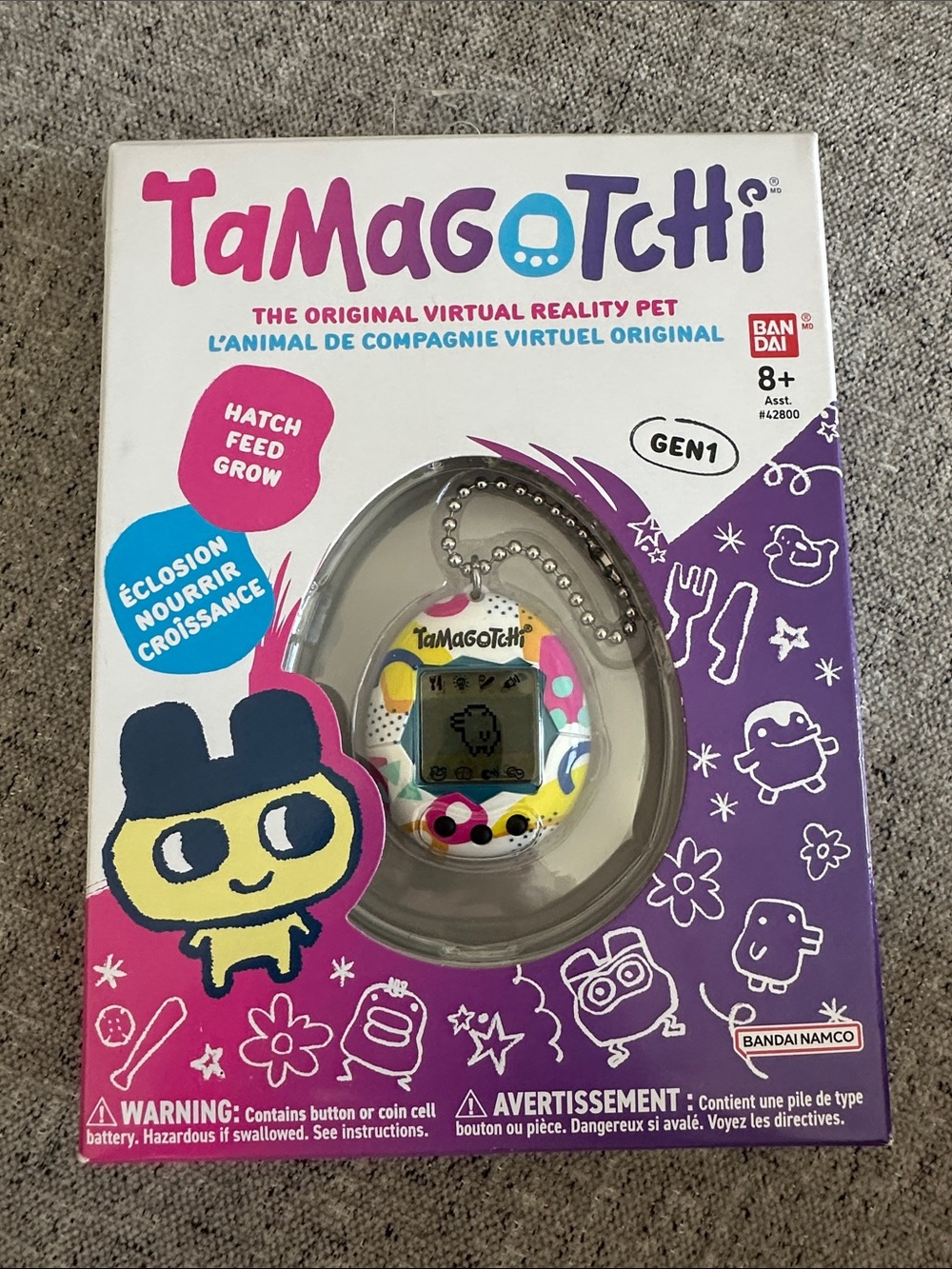 Tamagotchi Gen1 Virtual Pet Keychain - White with Multicolor Spots